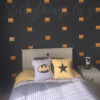 Superhero Mask Wall Pattern Sticker behind a bed in a boys room
