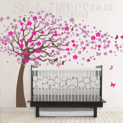 The Blowing Cherry Tree Wall Art is a giant tree with hundreds of cherry blossoms on the tree and blowing around the room