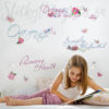 Girl reading a fairy tale in front of her Disney Princess Quote Wall Decals