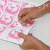 Hand showing how easy the Peel and Stick Pink Alphabet Letters Wall Stickers are