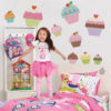 Girl jumping in her bedroom with Giant Cupcake Wall Decals on her walls