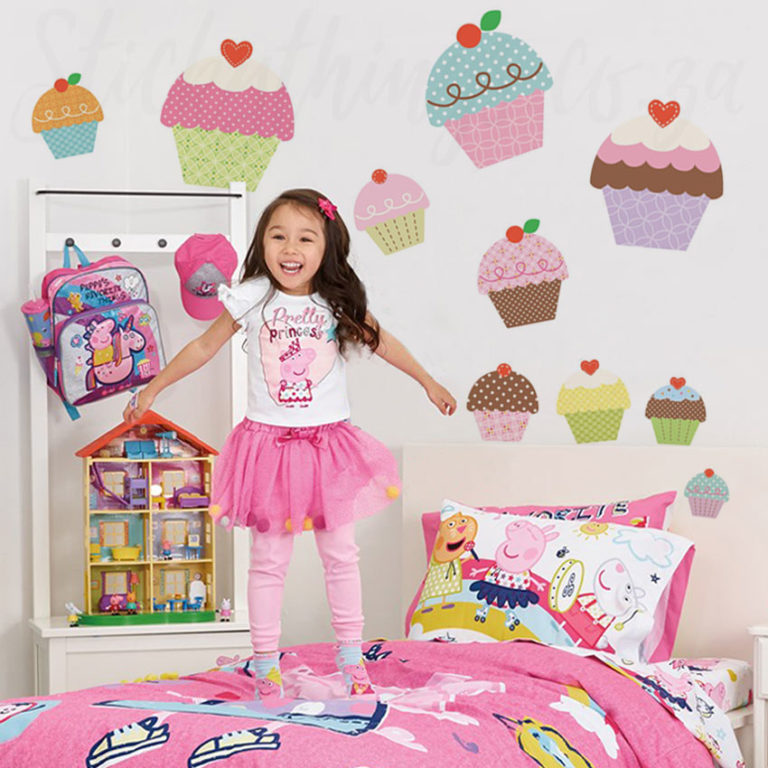 Girl jumping in her bedroom with Giant Cupcake Wall Decals on her walls