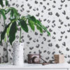 Light Grey Leopard Print Wallpaper on a wall behind a plant in an entrance hall