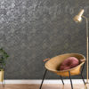Navy and Gold Industrial Wallpaper on a wall behind a chair, a plant and a lamp