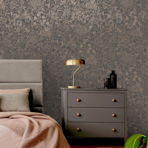Rose Gold Flowers Wallpaper on a bedroom wall behind a headboard and a bedside table