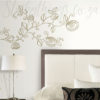 Matt Gold Roses Wall Stickers on a bedroom wall near a headboard and a lamp.
