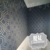 Gold Navy Geometric Wallpaper on a bathroom wall