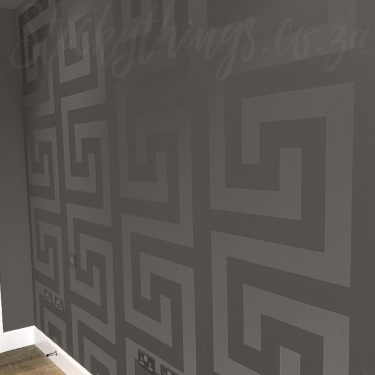Versace Charcoal Greca Wallpaper on a wall